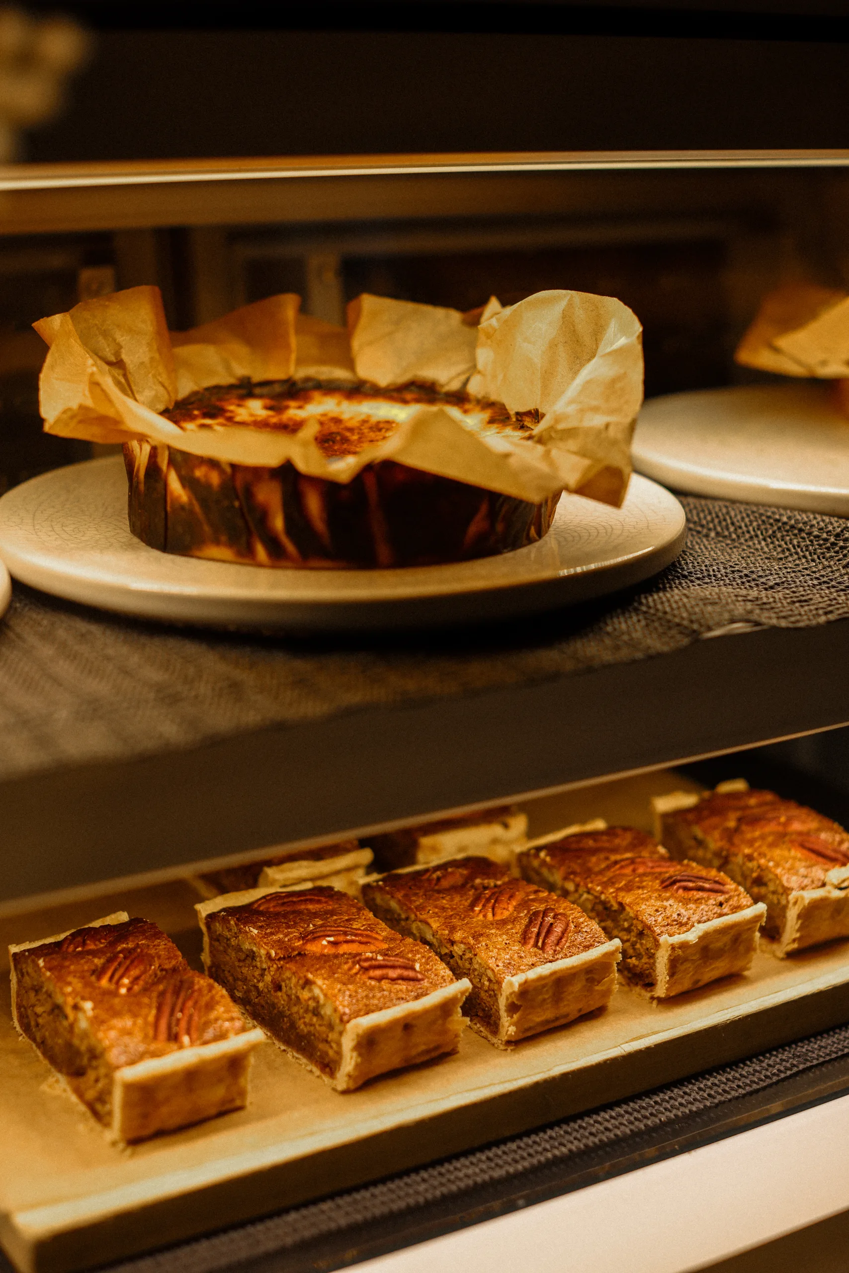 Warm pecan pie with a scoop of tonka bean ice cream, Basque burnt cheesecake